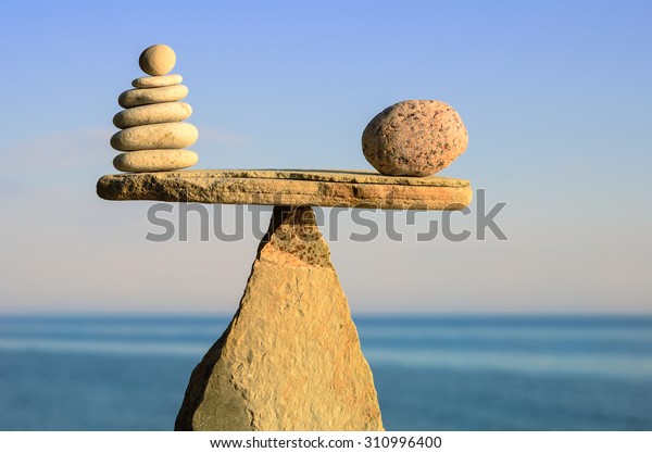 Symbol of scales is made of pebbles on the seashore