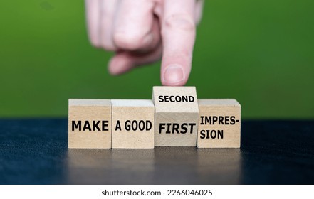 Symbol for a second chance. Hand turns wooden cube and changes the expression 'make a good first impression' to 'make a good second impression'.