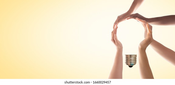 Symbol and shape of bulb created from hands. The concept of idea, cooperation, teamwork and creative solution. - Shutterstock ID 1660029457