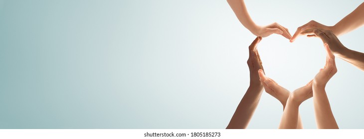 Symbol and shape of heart created from hands.The concept of unity, cooperation, partnership, teamwork and charity. - Shutterstock ID 1805185273