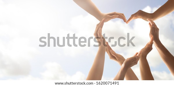Symbol
and shape of heart created from hands.The concept of unity,
cooperation, partnership, teamwork and
charity.