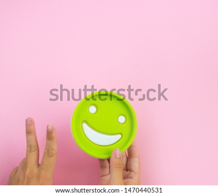Symbol of a smile in the hands of a girl