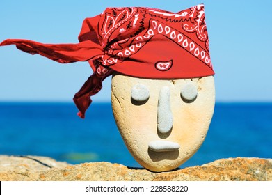 Symbol Of Stone Head  With A Patterned Red Bandana 