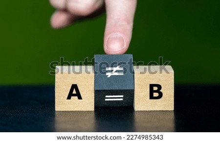 Symbol  that A does not equal B. Hand turns cube and changes the equation 'A equal to B' to 'A unequal to B'.