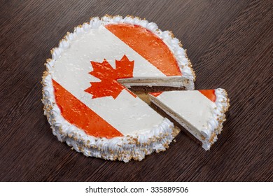 The Symbol Of War And Separatism: A Cake With A Picture Of The Flag Of Canada Is Broken Into Pieces