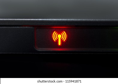Symbol wireless network signal lights while working on laptop.