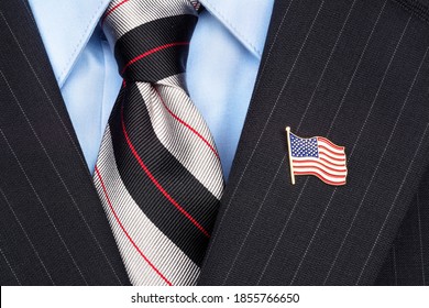 A Symbolic American Flag Lapel Pin On The Collar Of A Businessman's Suit
