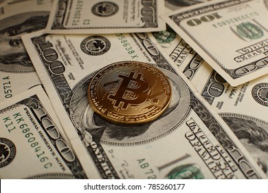 A symbolic coins of bitcoin on banknotes of one hundred dollars. Exchange bitcoin cash for a dollar.
