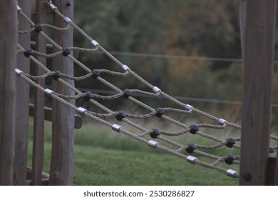 Symbolic image of a children's climbing rope bridge at a playground. Represents active play, child development, and outdoor recreation in safe, fun environments. - Powered by Shutterstock