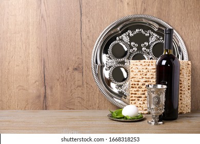 Symbolic Pesach (Passover Seder) Items On Wooden Table, Space For Text