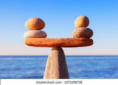 Symbolic scale of the stones on sea background closeup. Concept of harmony and balance. work-life, emotional balance