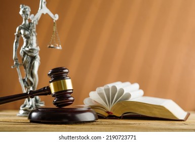 Symbols Of A Fair Trial. An Open Book - The Bible, A Wooden Gavel Of A Judge And A Bronze Figurine Of Themis - The Goddess Of Justice On A Beige Background. Banner.