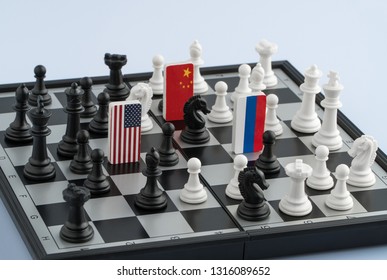 Symbols Flag Of Russia, United States And The China On The Chessboard. The Concept Of Political Game.