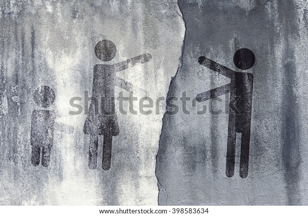 Symbols of men and women with a child pulling hands\
towards each other against the background of a concrete wall\
divided by cracks.\
Toned