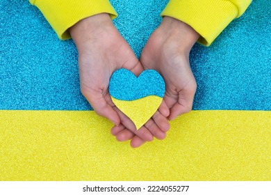 symbols of Ukraine. flag of Ukraine. children's hands hold a heart on the flag of Ukraine.Top view. - Shutterstock ID 2224055277