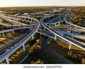 symetrical turnaround interchanges elevated Transportation Highway aerial drone sunrise over busy road way in Austin , Texas , USA