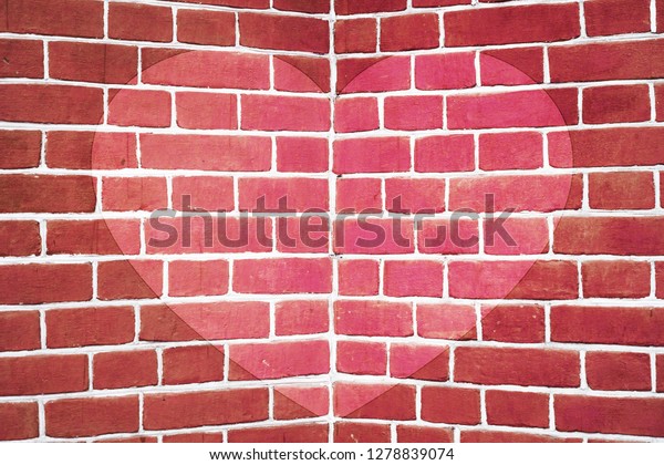 Symmetric pink drawn heart on red brick wall\
close-up. Background with painted heart. Interior with love symbol\
decor. Valentine day image on wall. Brickwork with exterior\
picture. Angle of brick\
wall