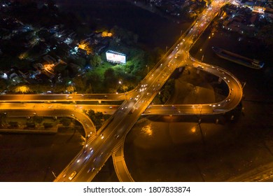 symmetrical Aerial view of freeway interchange offramp and bridge over canal with traffic