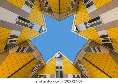 Symmetrical and converging cubic houses against a blue sky Stock Photo
