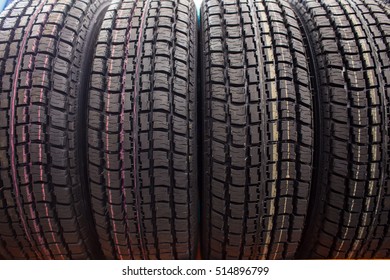 Symmetrical demi seasonal tires on the shelf at the tires store
 - Powered by Shutterstock