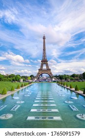 Symmetrical front panoramic view of Eiffel tower on a bright Summer day taken from fountains of Trocadero.