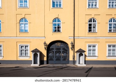 Symmetrical front view of the main gate and sentry boxes at Riga Castle entrance
