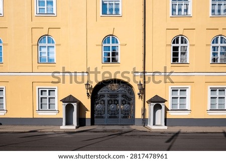 Symmetrical front view of the main gate and sentry boxes at Riga Castle entrance