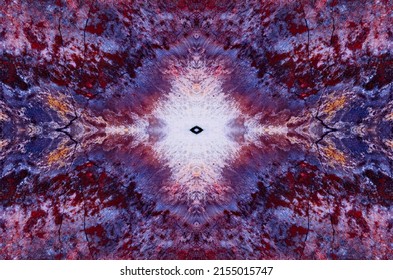 A symmetrical pattern formed by multi-colored spots of natural stone jasper texture. Natural pattern of slice of multicolored jasper stone. The image with the mirror effect.