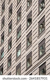 Symmetrical pattern of modern facade with repeating rectangular windows