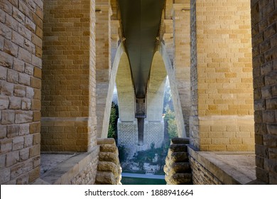 Symmetrical Pillars And Arches At The Base Of The Adolphe Bridge From The Pétrusse Park In Luxembourg City. 