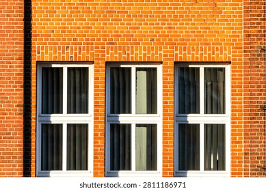 Symmetrical Red Brick Wall Facade with Three Windows