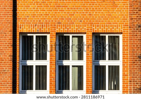 Symmetrical Red Brick Wall Facade with Three Windows