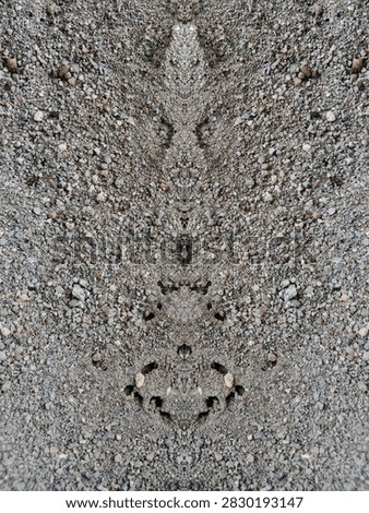 Symmetrical Sand Texture Pattern 

Close up of grey gravel sand with a unique mirrored symmetrical pattern, ideal for abstract background.