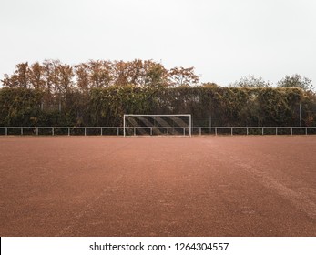 Symmetrical shot of a Rural Cinder soccer pitch in Germany