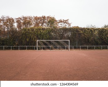 Symmetrical shot of a Rural Cinder soccer pitch in Germany