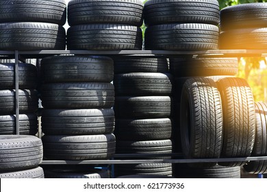 Symmetrical tires on the shelf at the tires store parts shop or tires background with sunlight or car tires in a row on a shelf tire - Powered by Shutterstock