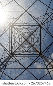 Symmetrical tower structure viewed from below, forming repetitive triangles.