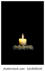 Sympathy Card With White Roses With A Burning Candle On The Dark Background. Funeral Flower Condolences Card. Mood, Prayers And Deepest Sympathy Concept. Empty Place For A Text