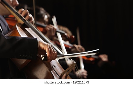 Symphony concert, a man playing the cello, hand close up - Shutterstock ID 120211573