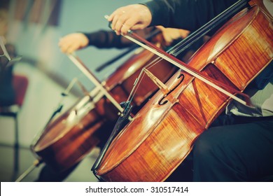 Symphony Orchestra On Stage, Hands Playing Violin.
Shallow Depth Of Field, Vintage Style.