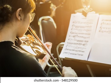 Symphony Orchestra On Stage, Hands Playing Violin. Shallow Depth Of Field, Public Place.