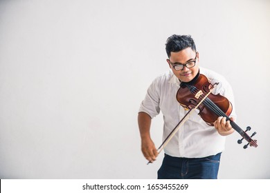 Symphony Orchestra On White Background, Hands Playing Violin. Male Violinist Playing Classical Music On Violin. Talented Violinist And Classical Music Player Solo Performance.