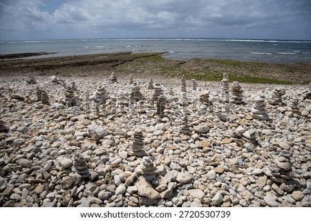 The symphony of pebbles under a dramatic sky. Thousands of shapes, carefully stacked, create a surreal and textured landscape. Infinity in mineral detail.