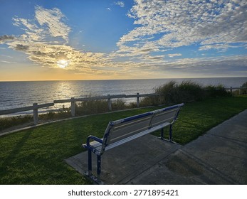A Symphony of Serenity Captured in the Stillness of an Empty Park Bench Overlooking the Vast and Timeless Majesty of the Open Sea.