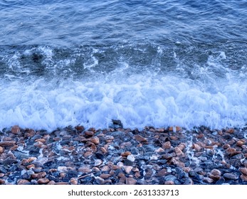 Symphony of Waves and Pebbles Under the Sunset Glow