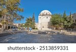 Synagogue with name Hurva in old city of Jerusalem, Israel timelapse hyperlapse with green trees and blue sky