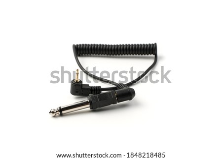 The sync cable with the connector and plug is isolated on a white background. Concept of accessories for equipment.