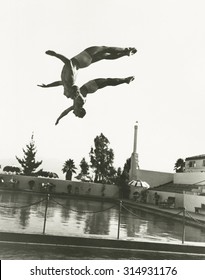 Synchronized Divers In Mid-air