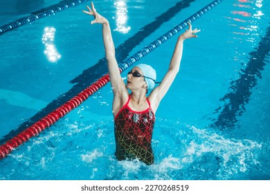 Synchronized girl working out tricks in the pool. Synchronized swimming, sports in the water. Professional sportswoman doing exercises in the pool. Training before the competition - Powered by Shutterstock