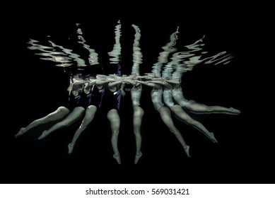 Synchronized Swimmers Take A Pose Underwater